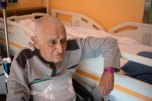 elderly man sitting in nursing home