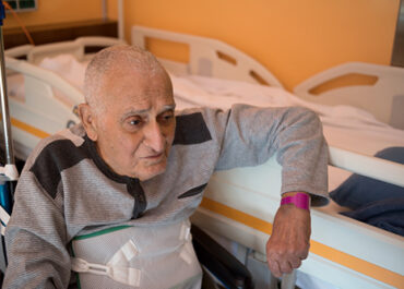 elderly man sitting in nursing home