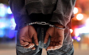 images of mans hands behind his back with handcuffs on